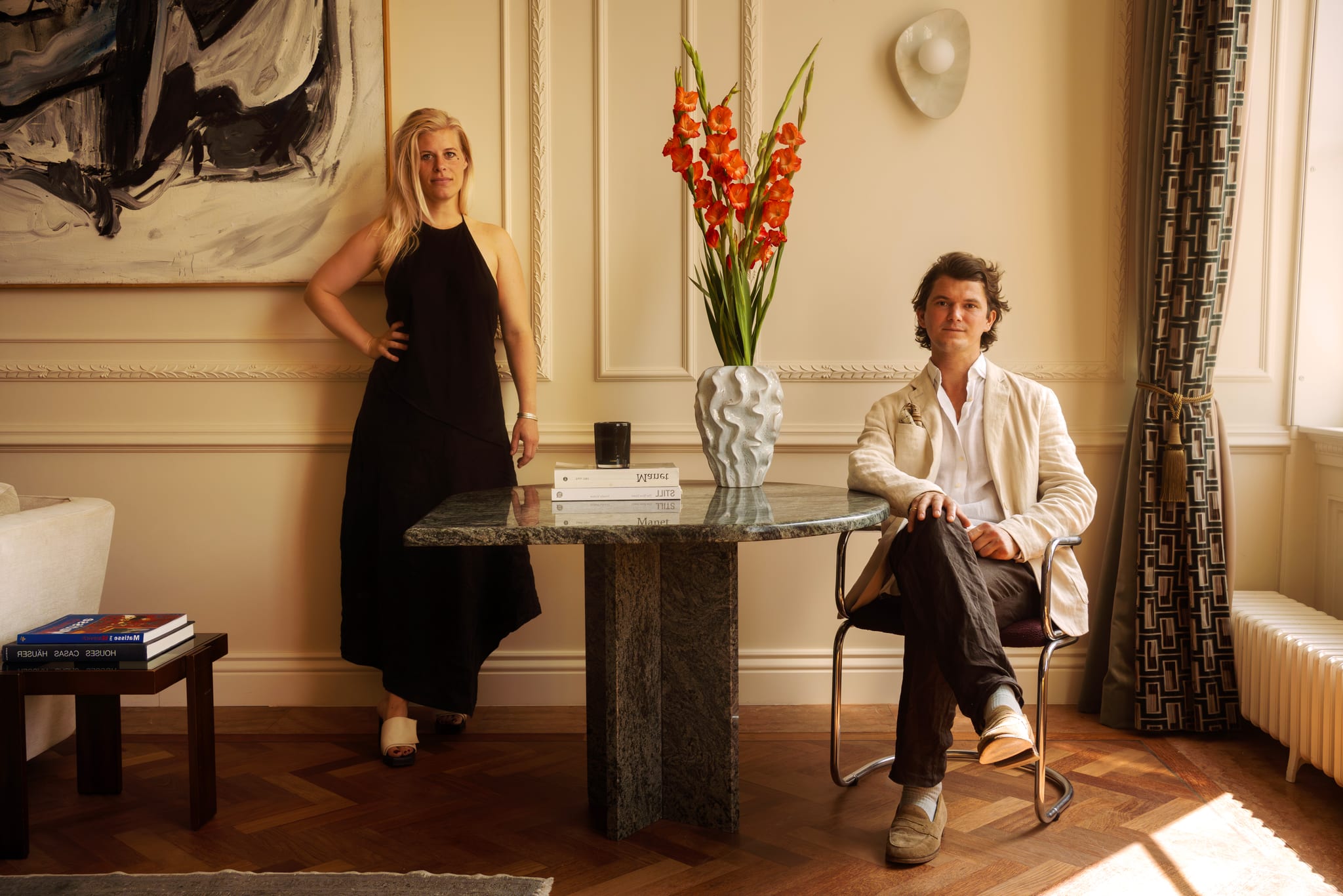 Maxime and Tristan at a marble table in a canal-house living room